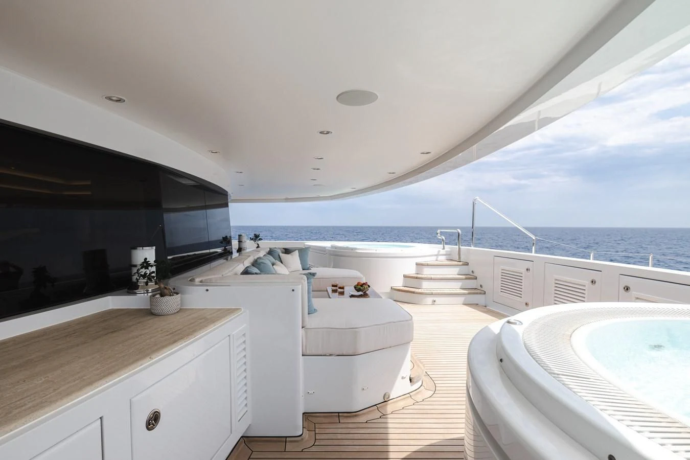 a large white kitchen with a large window overlooking the ocean aboard BATELLO Yacht for Sale