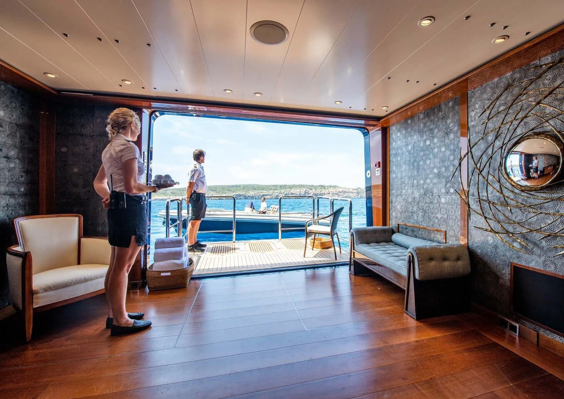 a person standing in a room with a pool and a large window aboard BATELLO Yacht for Sale