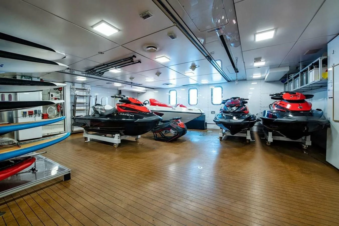 a room with a few cars in it aboard BATELLO Yacht for Sale