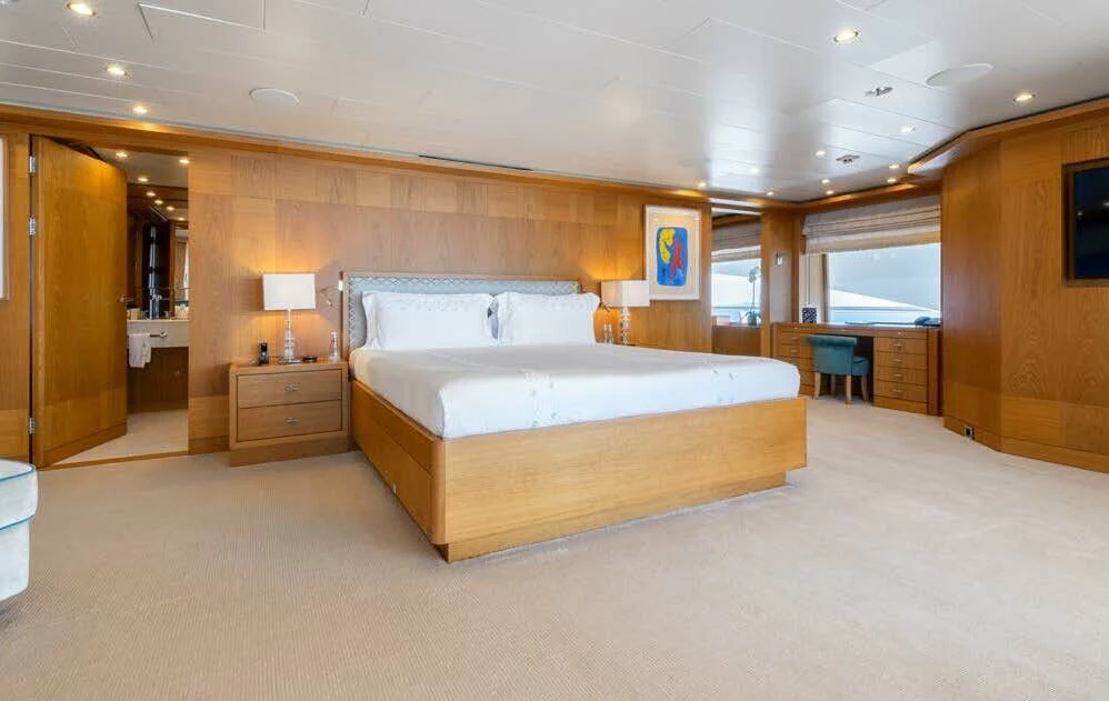 a large bedroom with a large bed aboard BATELLO Yacht for Sale