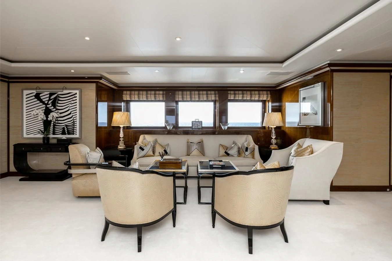 a living room with a large white couch and a large window aboard BATELLO Yacht for Sale