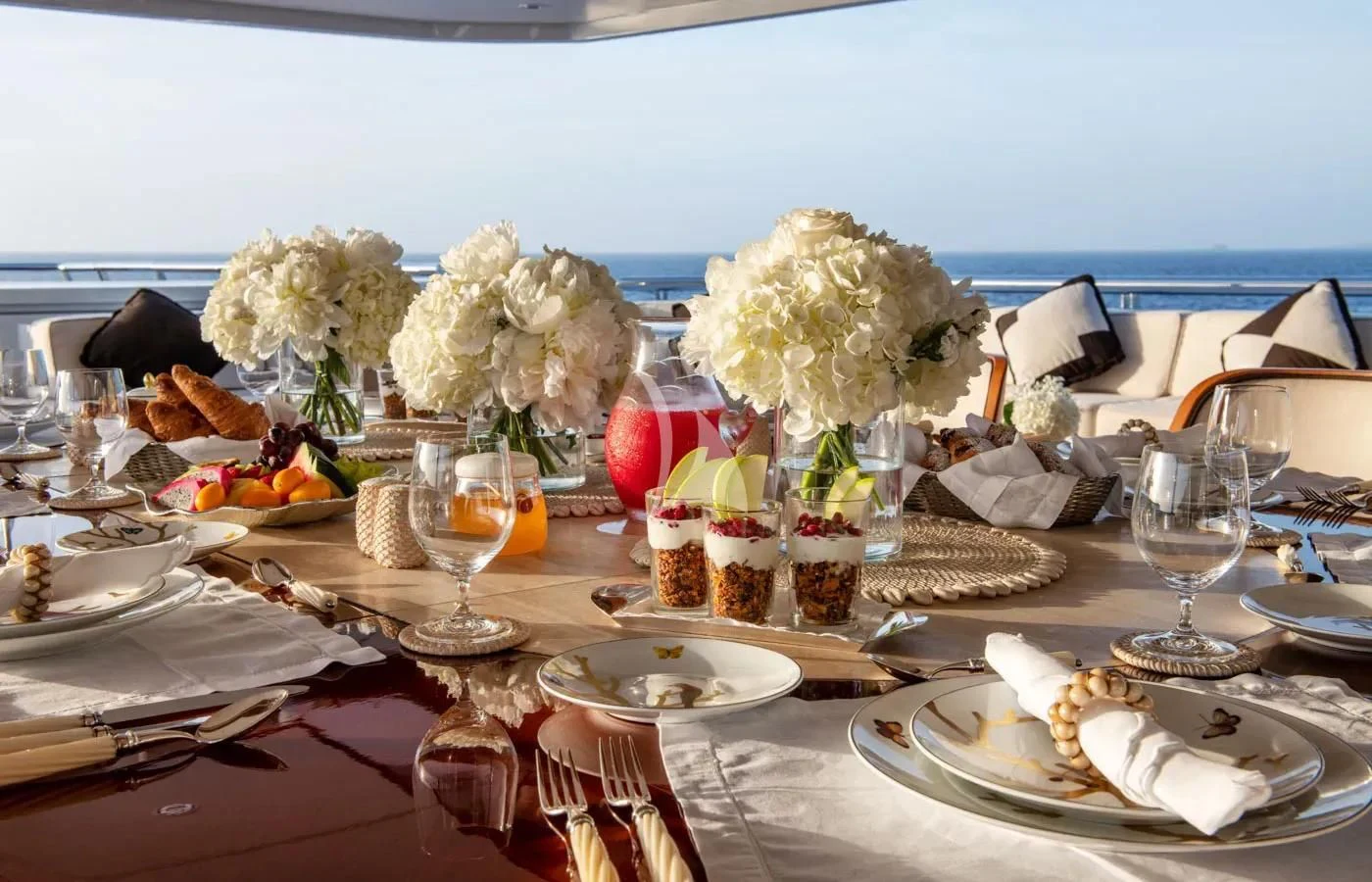 a table with plates and glasses aboard BATELLO Yacht for Sale