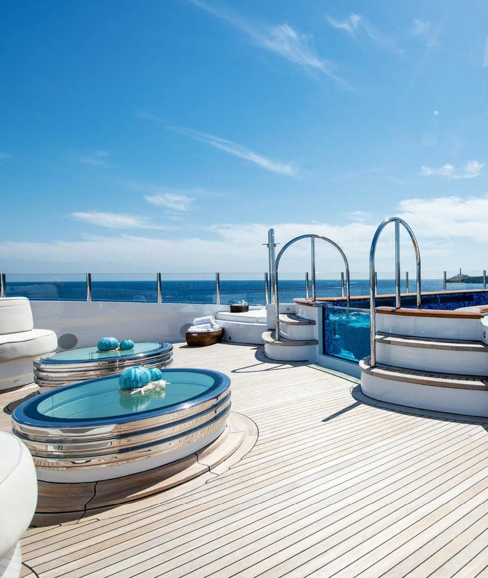 a deck with a table and chairs on it aboard BATELLO Yacht for Sale