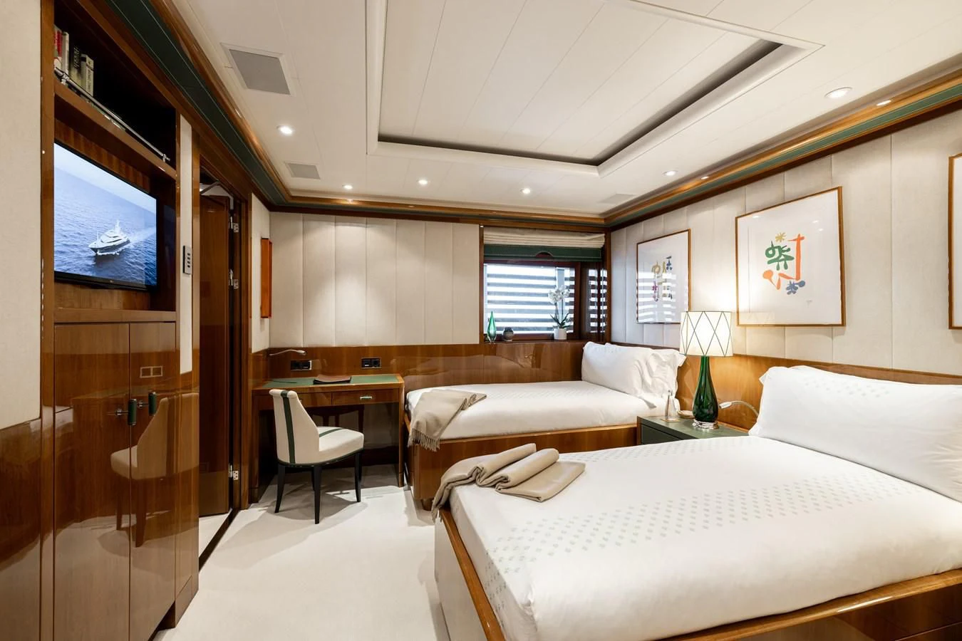 a room with a bed and a tv on the wall aboard BATELLO Yacht for Sale