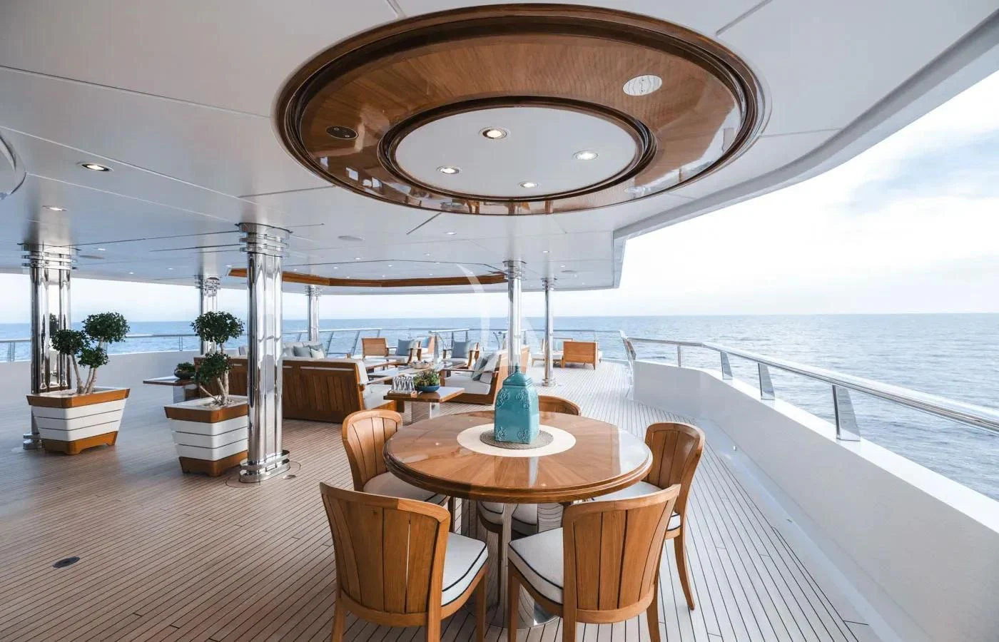 a large room with a table and chairs and a large outdoor bar aboard BATELLO Yacht for Sale