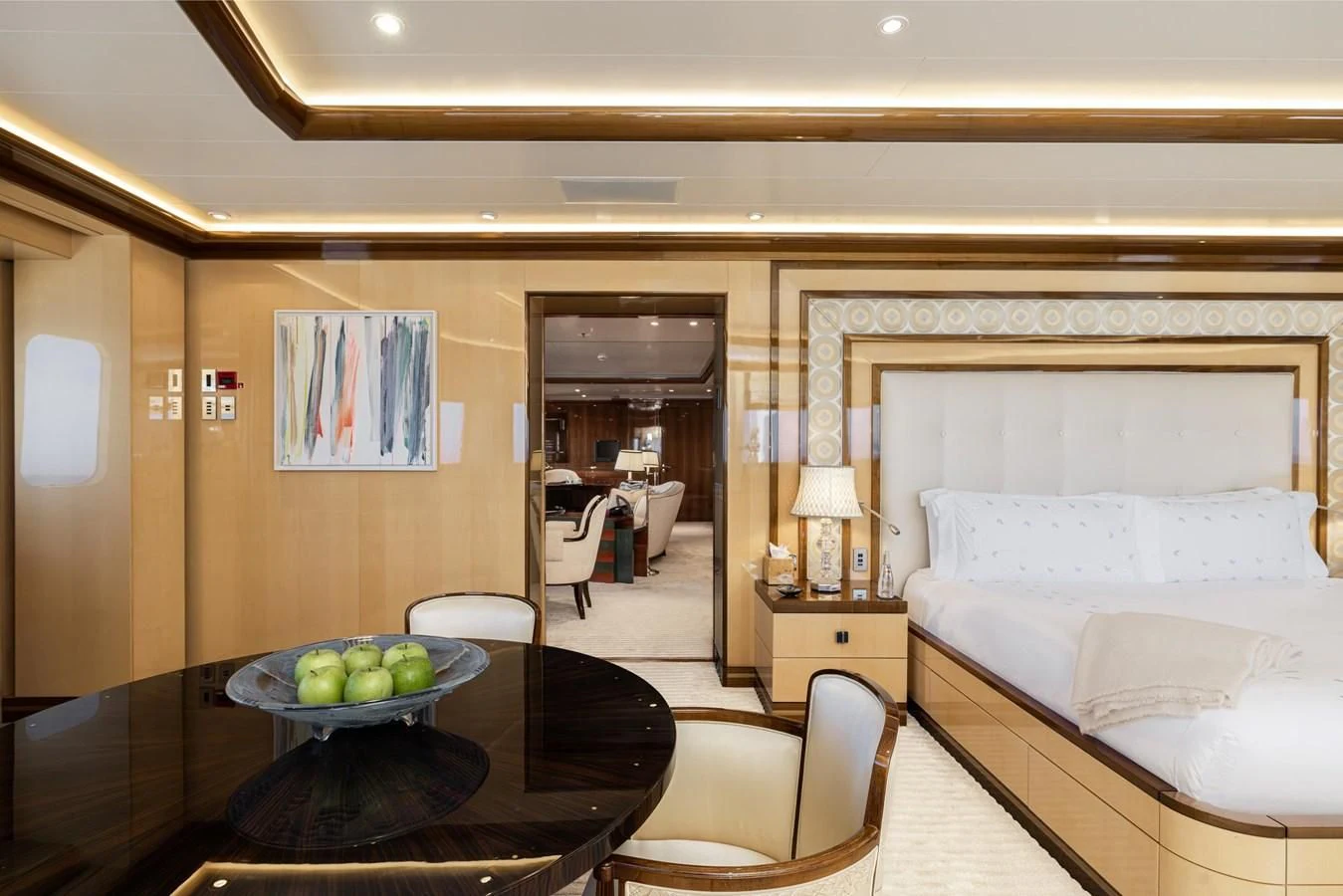 a hotel room with a table and chairs aboard BATELLO Yacht for Sale