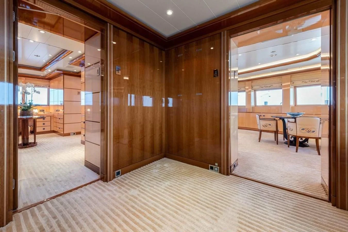 a room with a table and chairs aboard BATELLO Yacht for Sale