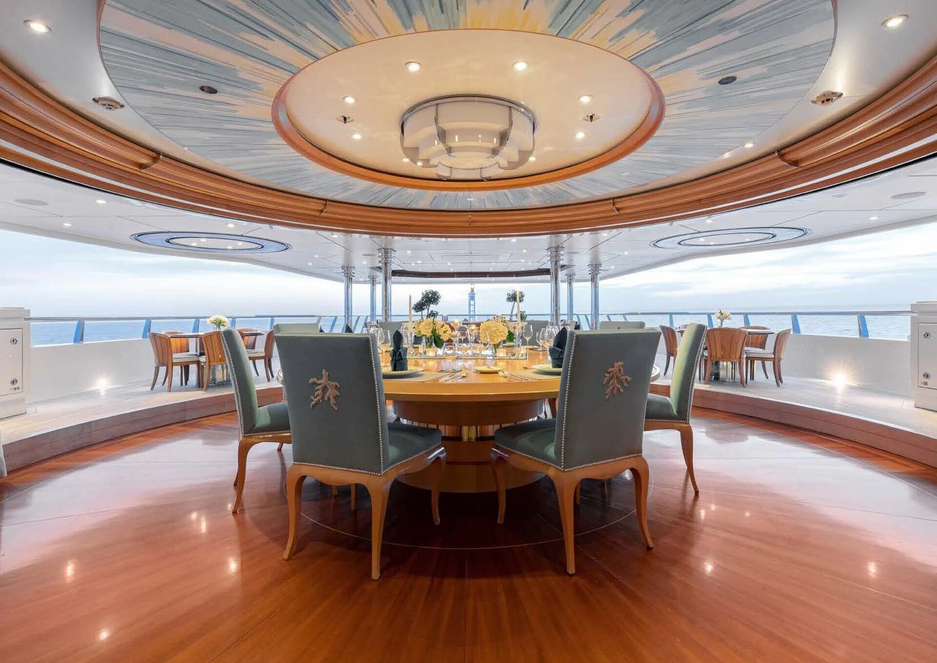 a room with a table and chairs aboard BATELLO Yacht for Sale
