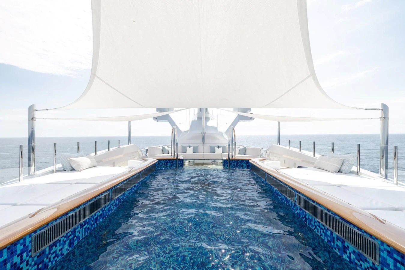 a large pool with a large white building in the background aboard BATELLO Yacht for Sale