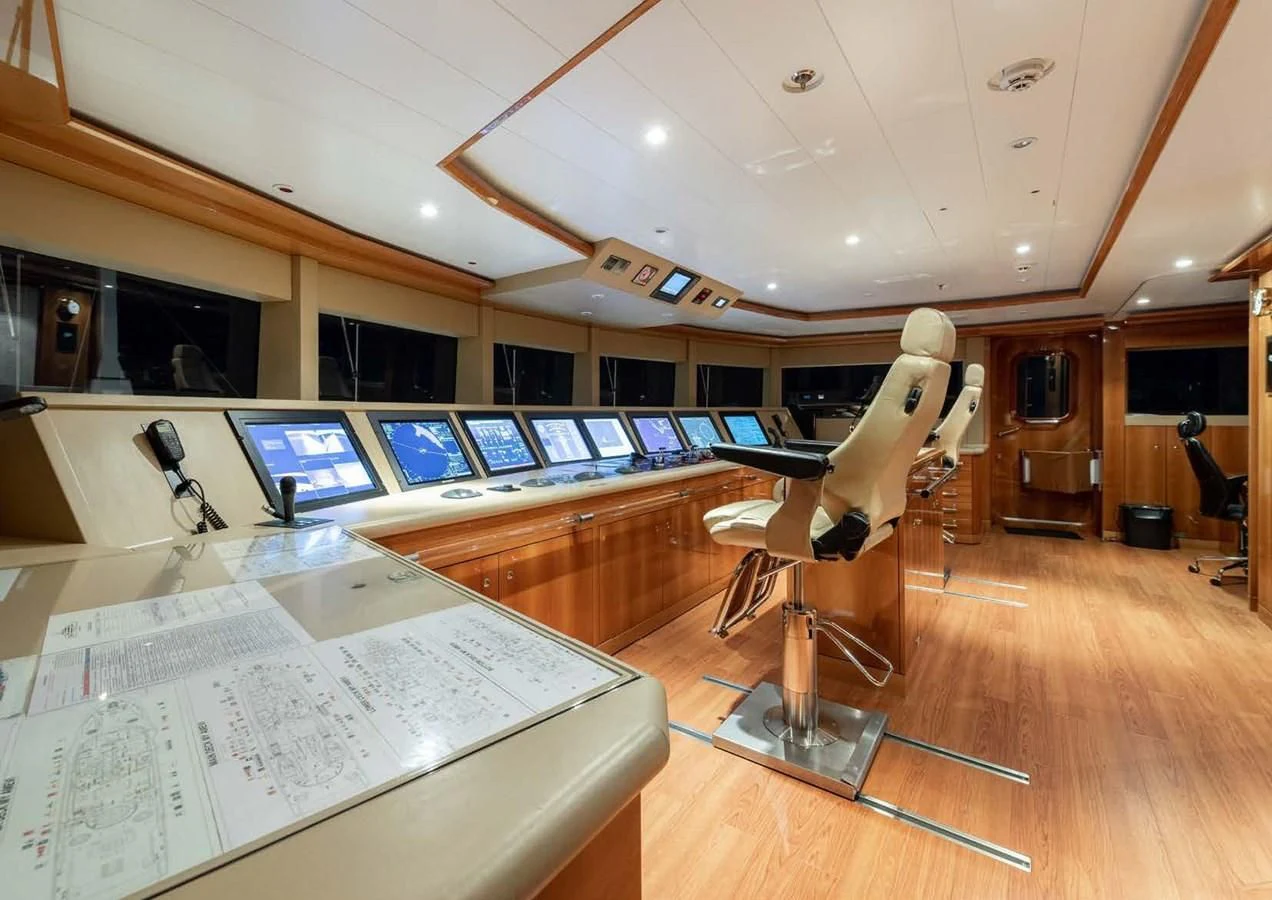 a statue of a duck on a stand in a room with a large screen and a wood floor aboard BATELLO Yacht for Sale