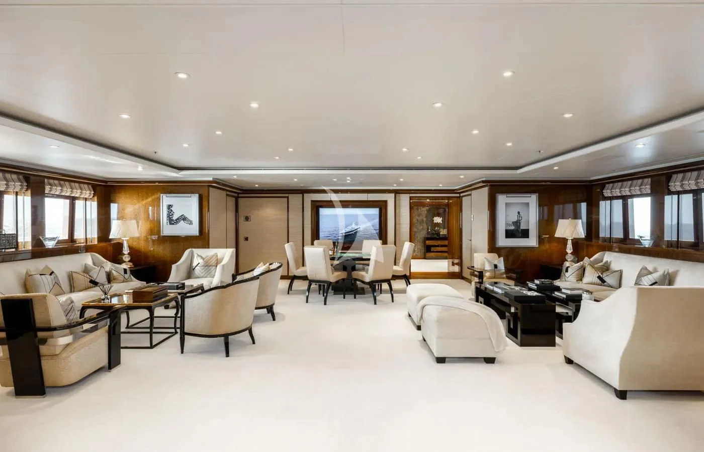 a large living room with white furniture aboard BATELLO Yacht for Sale