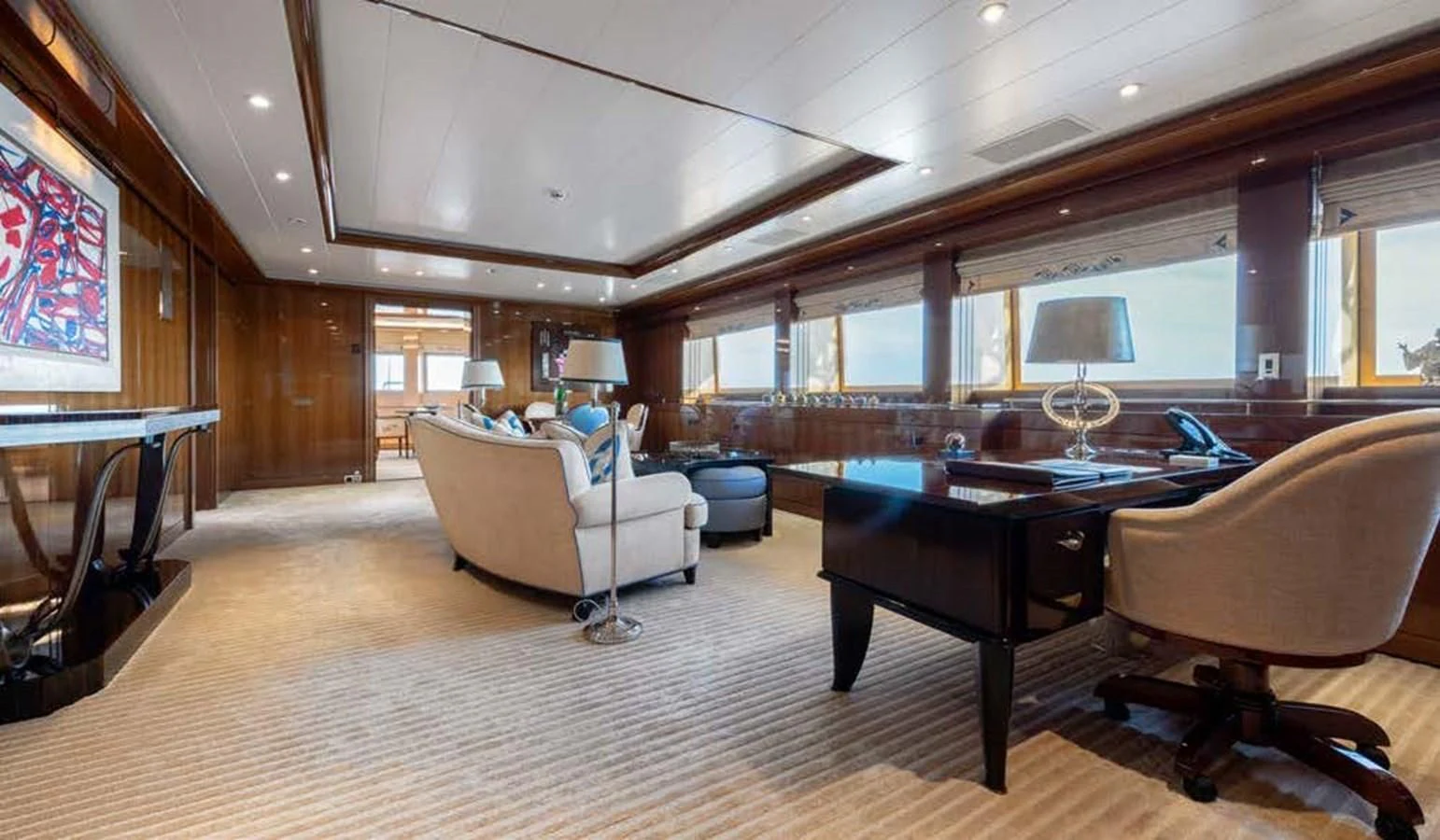a large living room with a large table and chairs aboard BATELLO Yacht for Sale