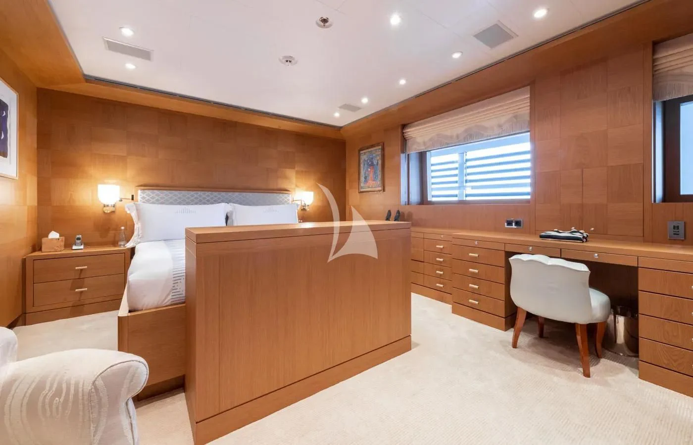 a bedroom with a bed and a desk aboard BATELLO Yacht for Sale