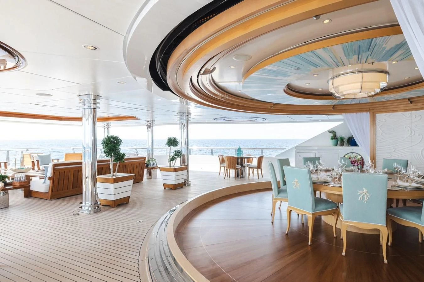 a room with a large table and chairs and a large window aboard BATELLO Yacht for Sale
