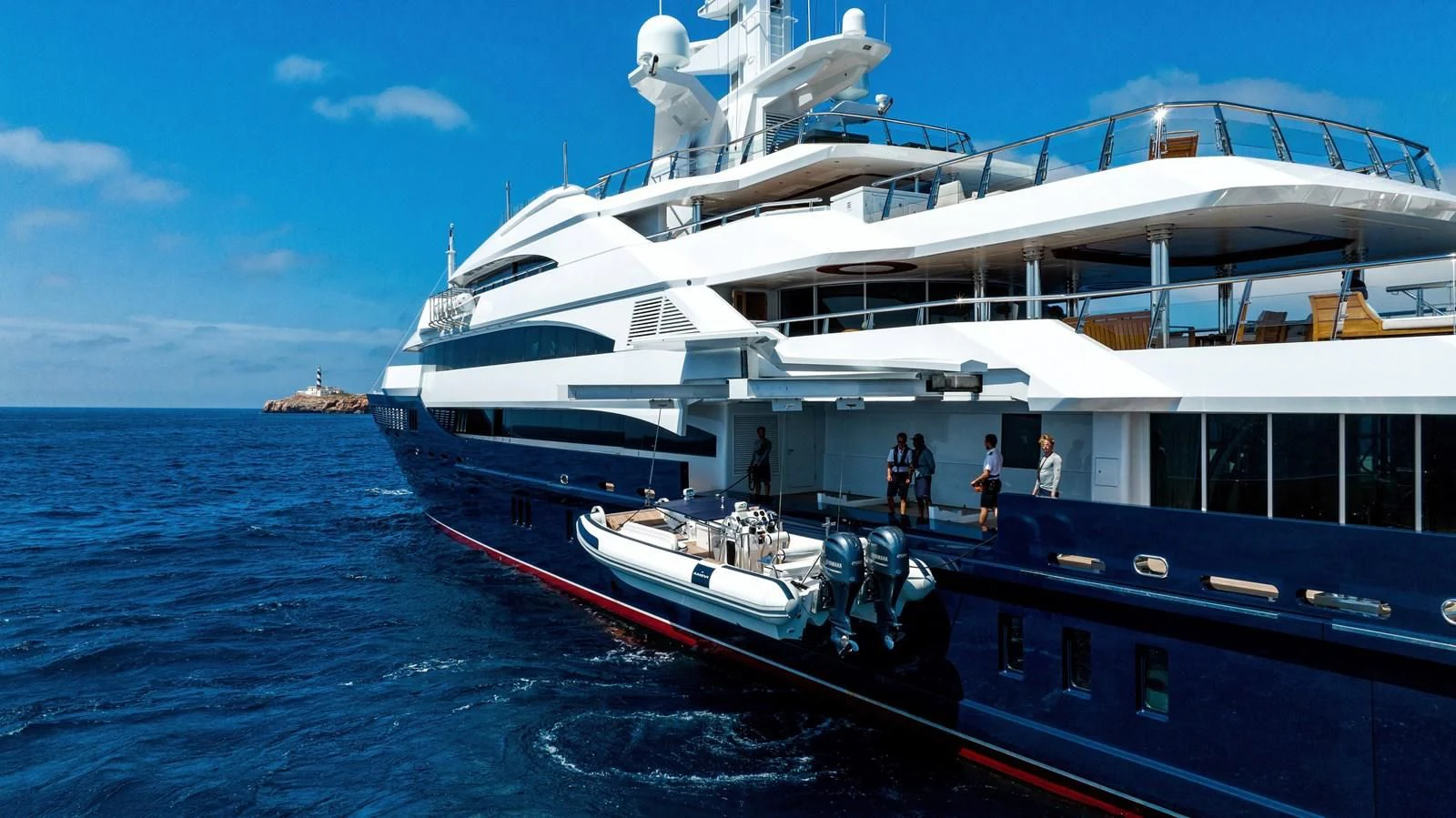 a boat with a deck and a dock with people on it aboard BATELLO Yacht for Sale
