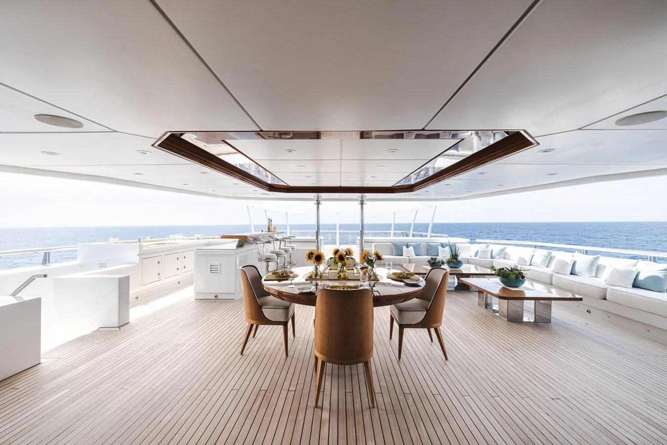 a room with a table and chairs aboard BATELLO Yacht for Sale