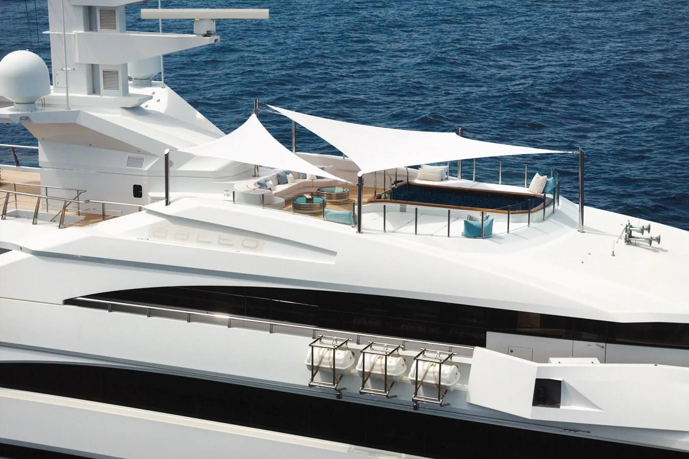 a white boat with a black and white deck and a white building with a blue roof and a aboard BATELLO Yacht for Sale