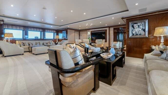 a person sitting on a couch in a living room aboard BATELLO Yacht for Sale