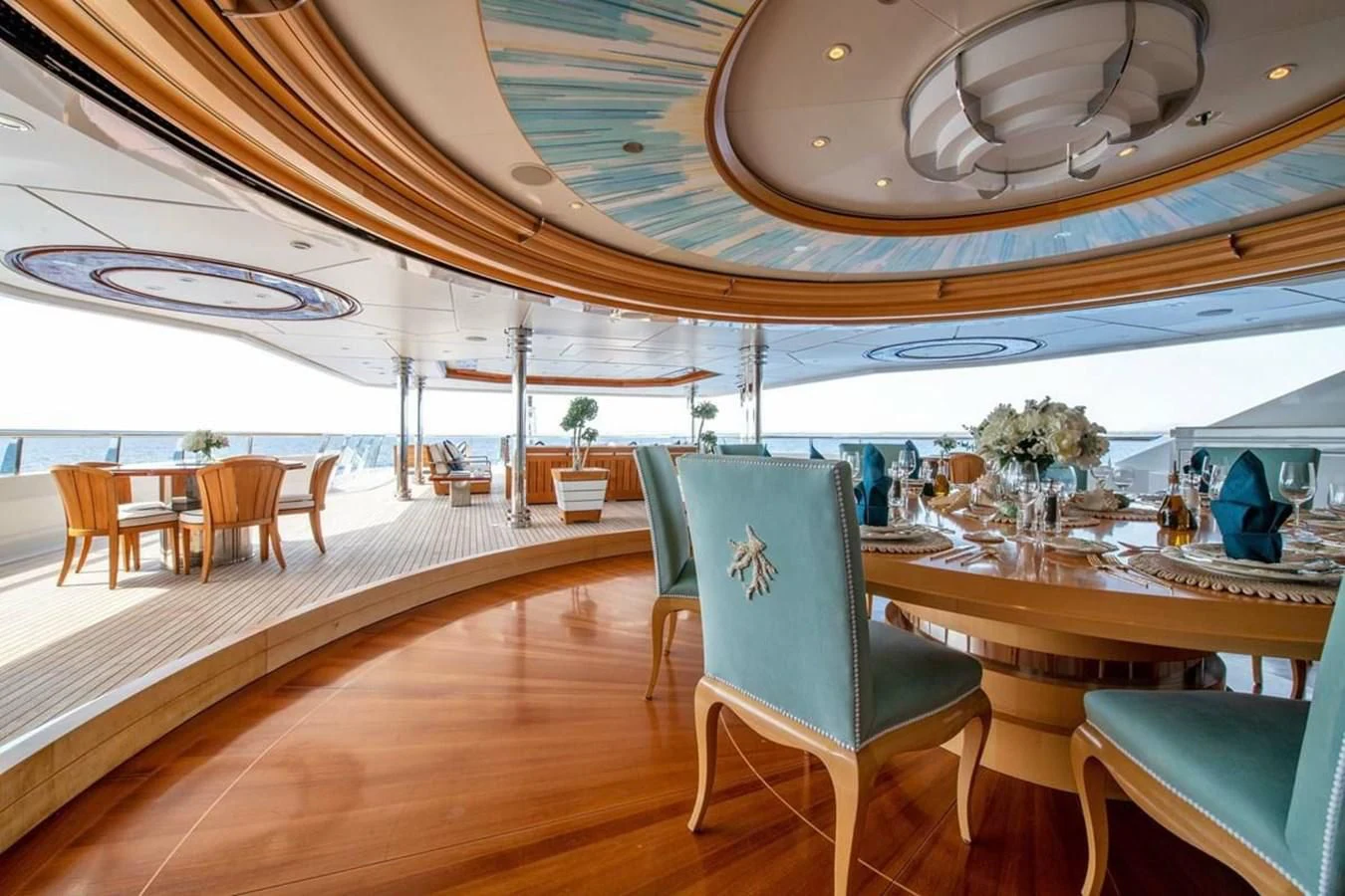 a room with tables and chairs aboard BATELLO Yacht for Sale