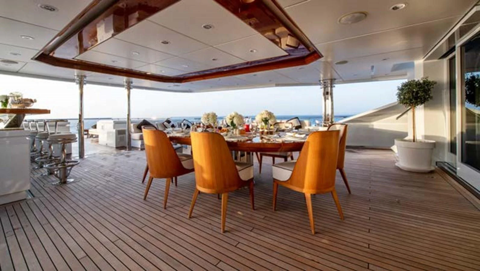 a large room with tables and chairs aboard BATELLO Yacht for Sale