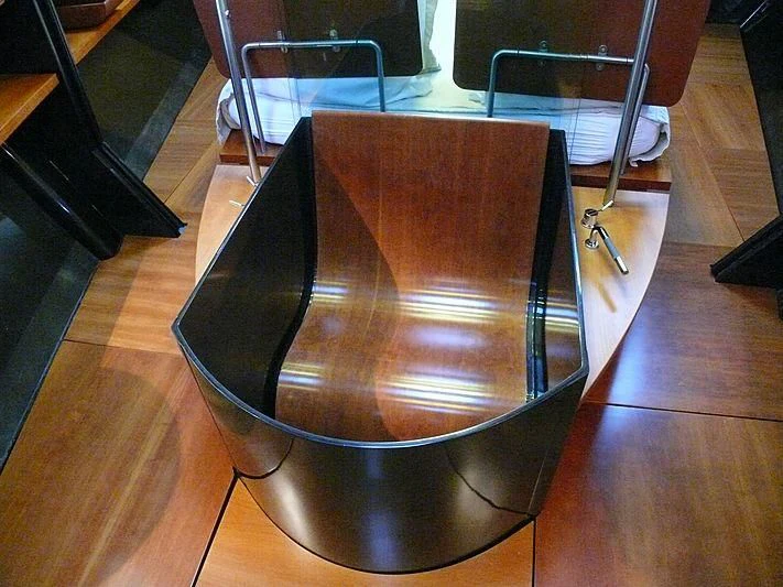 a black plastic bag on a wooden surface aboard WALLY B Yacht for Sale