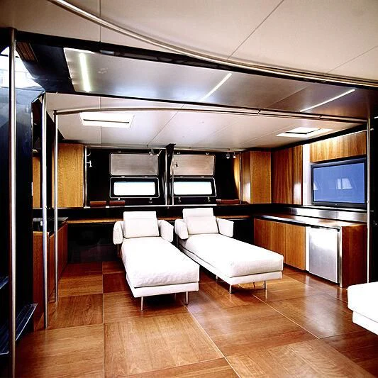 a room with a couch and a tv aboard WALLY B Yacht for Sale