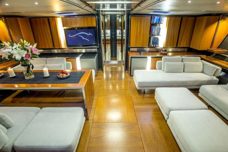 a room with a table and chairs aboard WALLY B Yacht for Sale