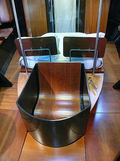 a wooden chair with a metal frame aboard WALLY B Yacht for Sale