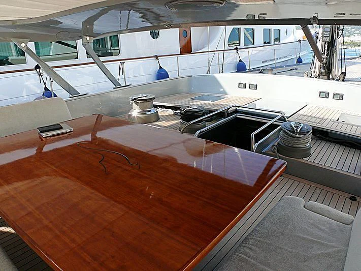 a large wooden table with a metal tray on it aboard WALLY B Yacht for Sale