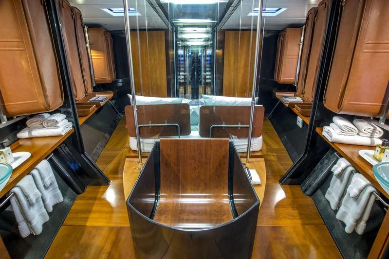 a train with a chair and desk aboard WALLY B Yacht for Sale