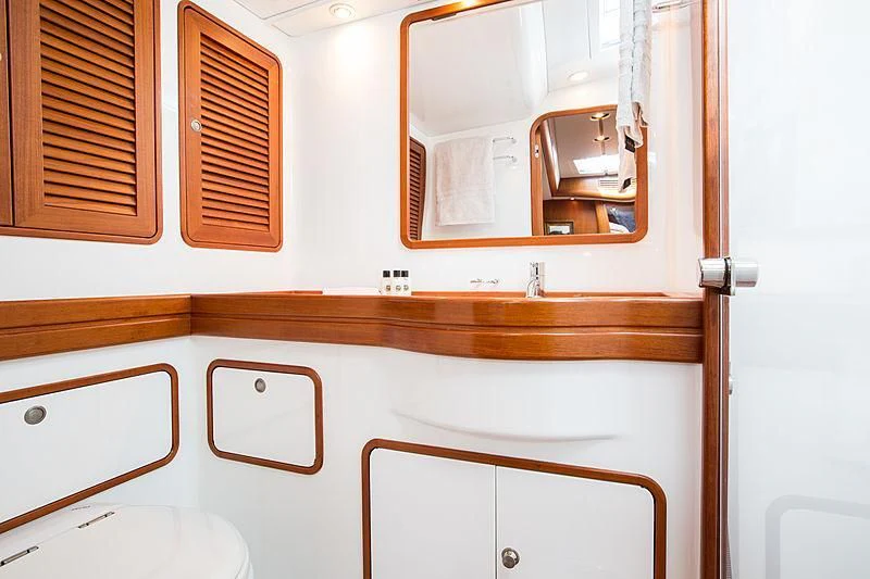 a bathroom with a mirror and cabinets aboard PAN Yacht for Sale