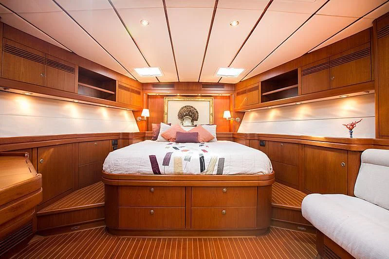 a room with a bed and a couch aboard PAN Yacht for Sale