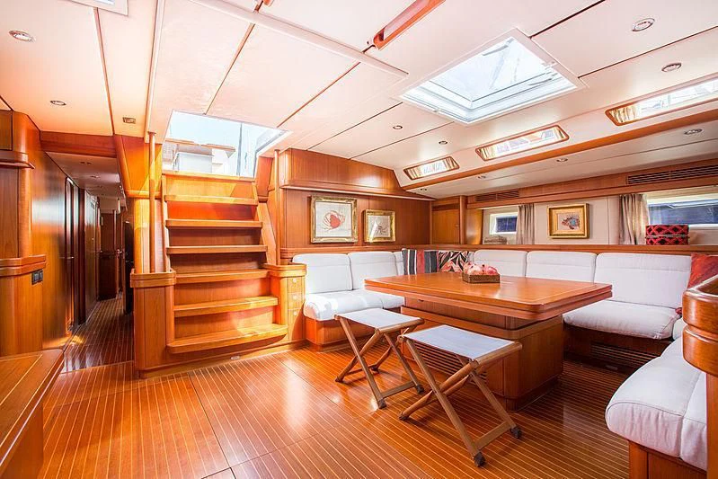 a room with a table and chairs aboard PAN Yacht for Sale
