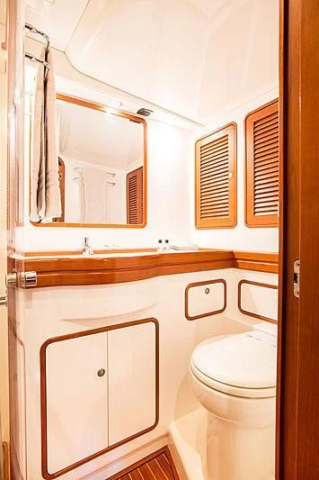 a bathroom with a toilet and sink aboard PAN Yacht for Sale