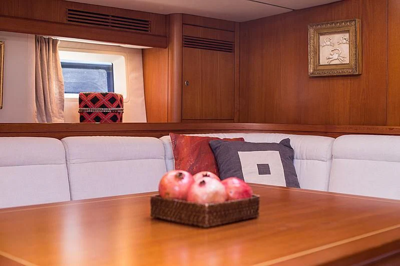 a couch with a basket of apples on it aboard PAN Yacht for Sale