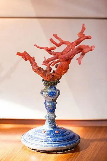 a glass vase with a red design aboard PAN Yacht for Sale
