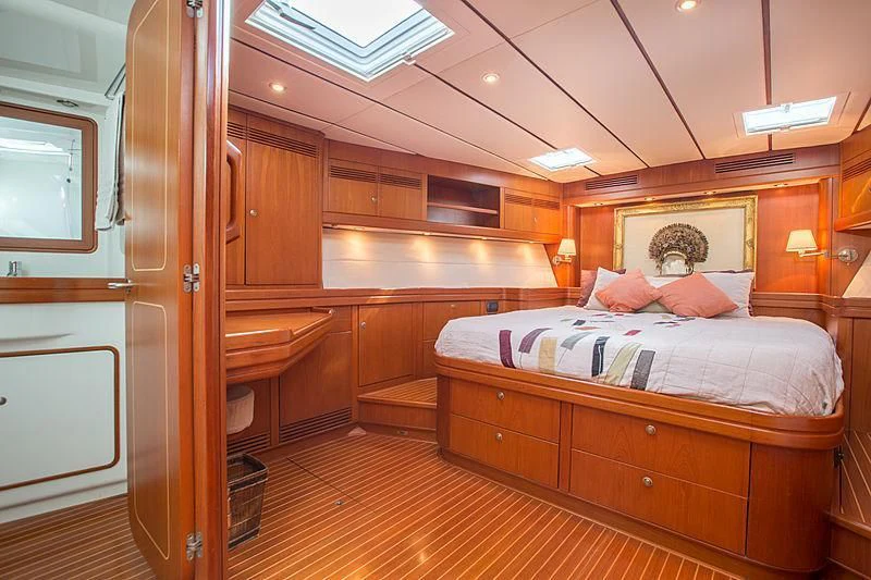 a bedroom with a bed and a closet aboard PAN Yacht for Sale