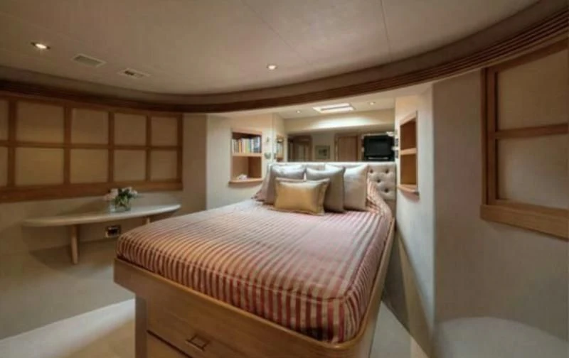 a bedroom with a bed and a desk aboard INTEGRITY Yacht for Sale