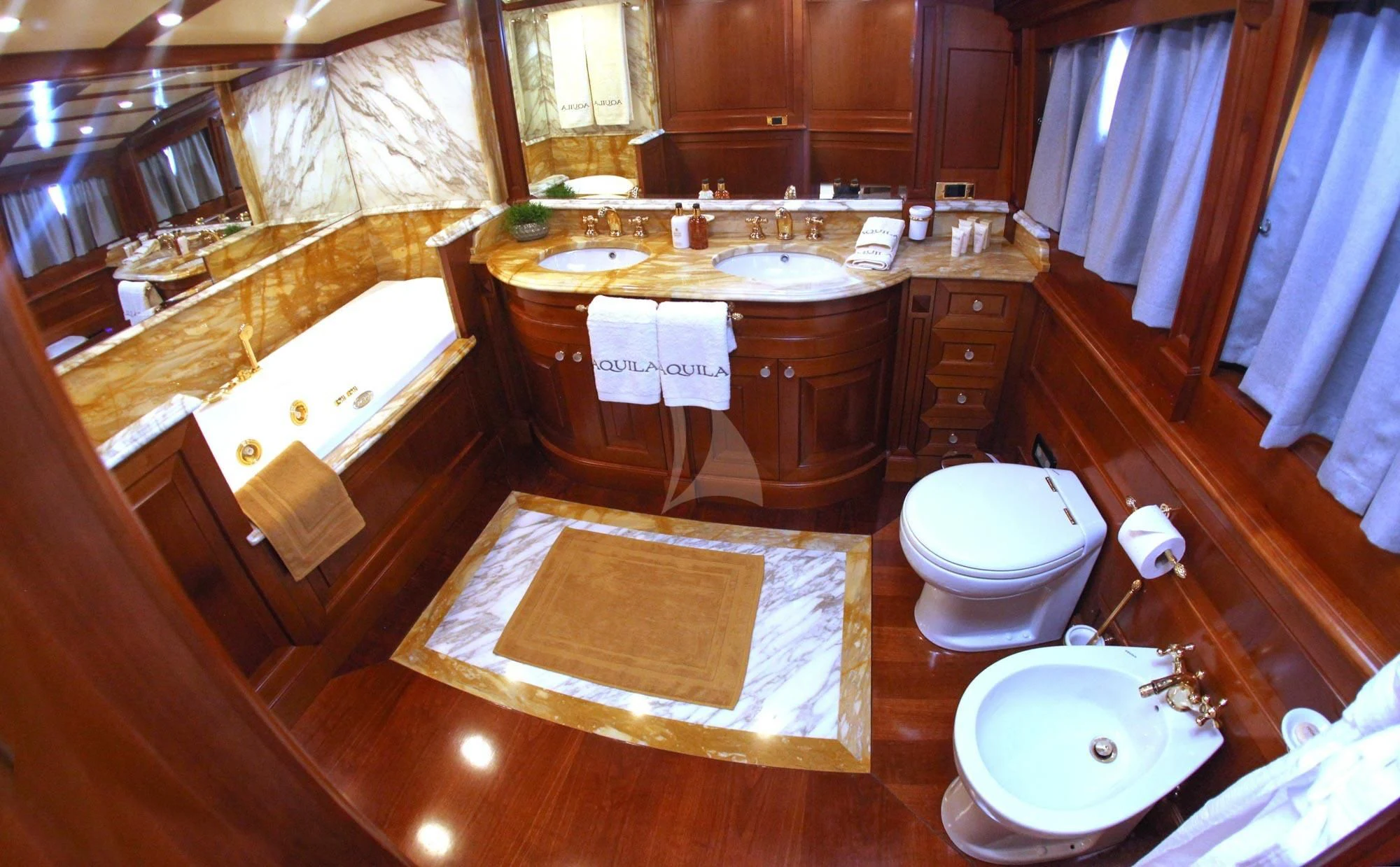 a bathroom with a sink toilet and bathtub aboard AQUILA Yacht for Sale