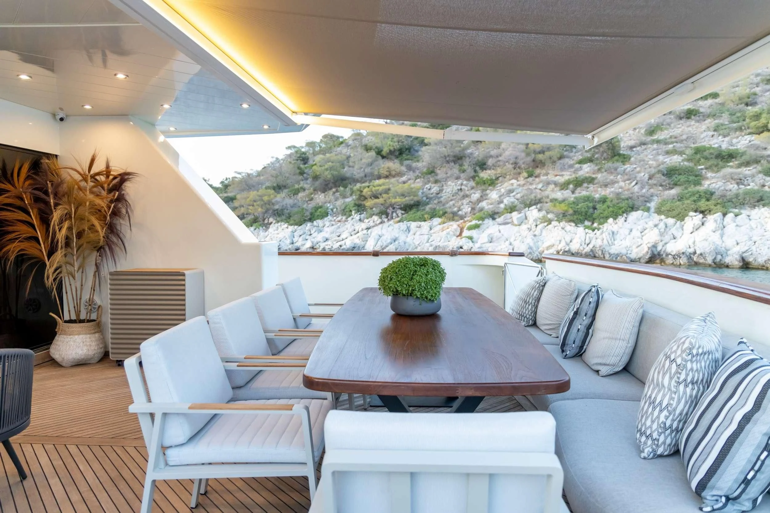 a table and chairs in a room aboard AQUILA Yacht for Sale