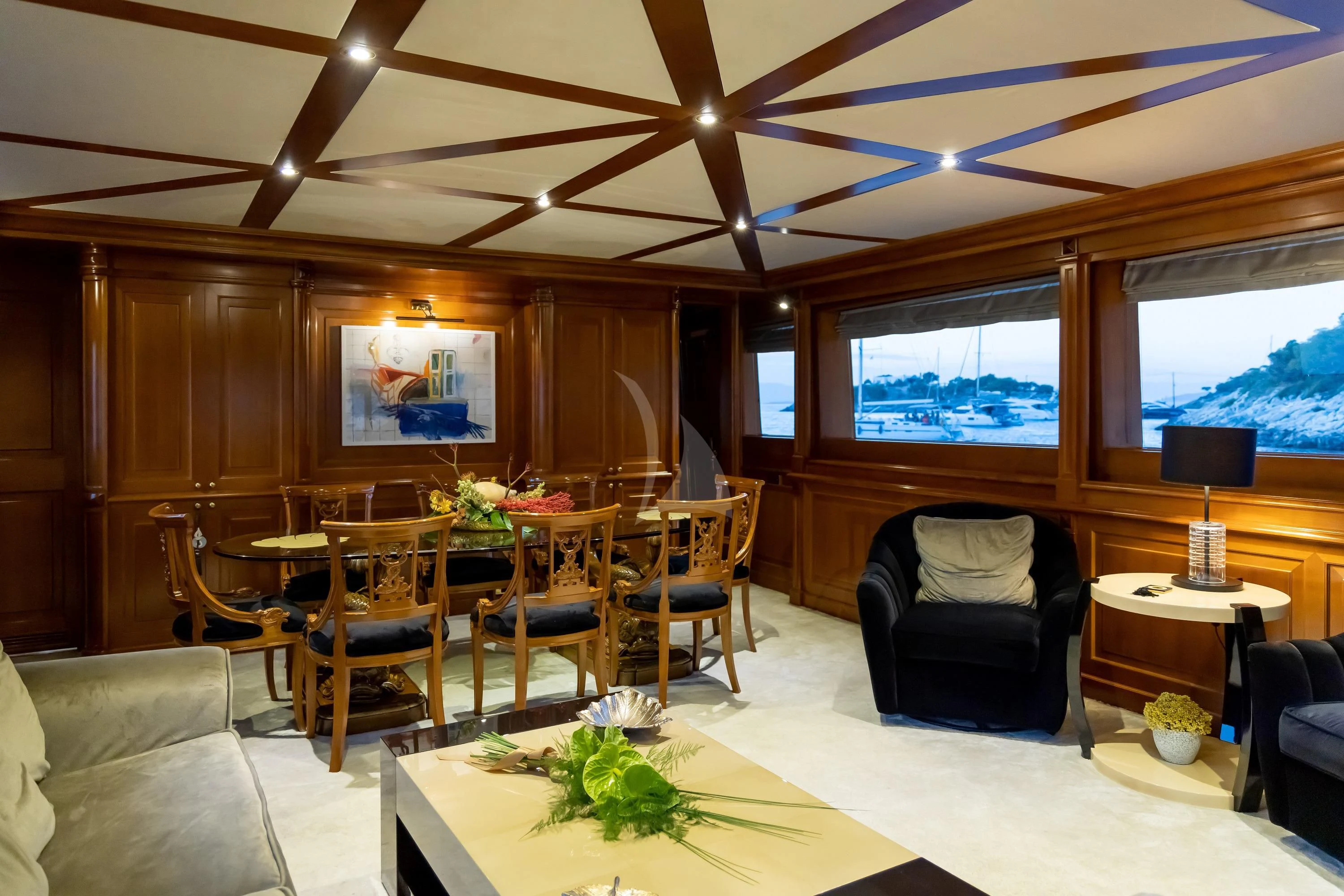 a living room with a table and chairs aboard AQUILA Yacht for Sale