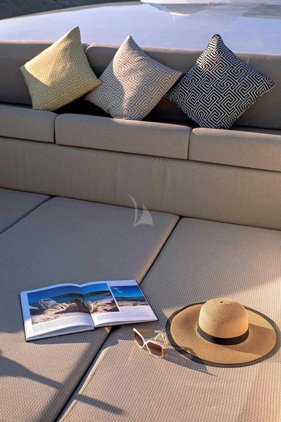 a table with a hat and sunglasses aboard AQUILA Yacht for Sale