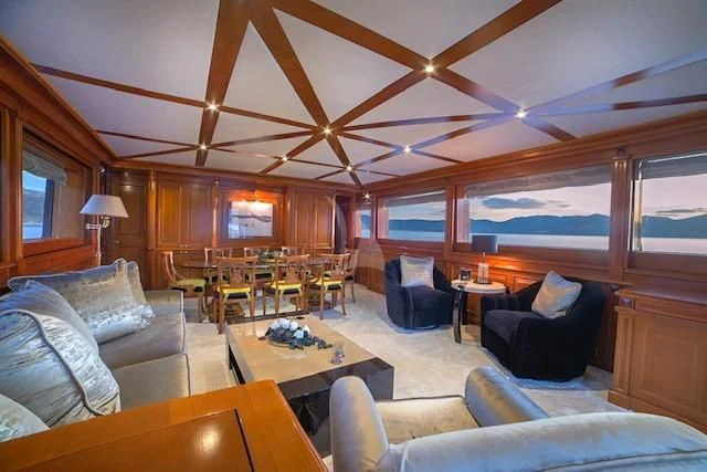 a living room with a large window aboard AQUILA Yacht for Sale