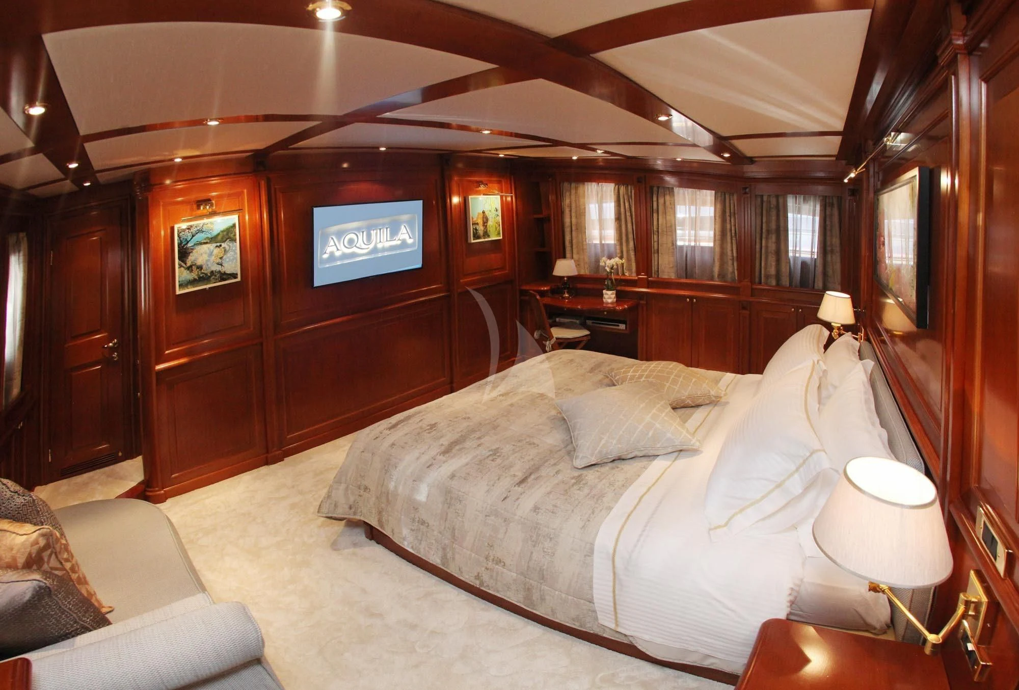 a bedroom with a bed and a television aboard AQUILA Yacht for Sale