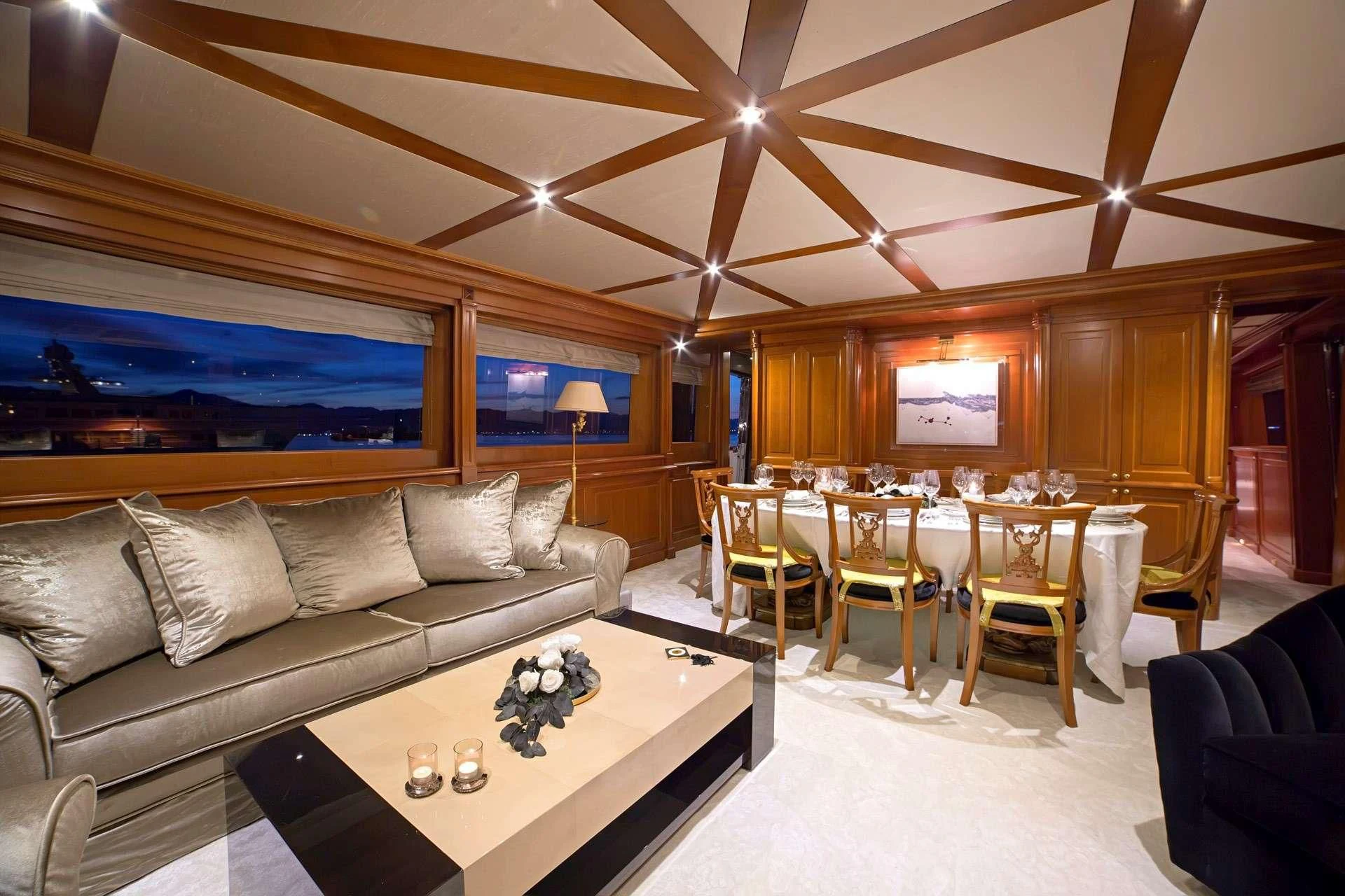 a living room with a large screen aboard AQUILA Yacht for Sale
