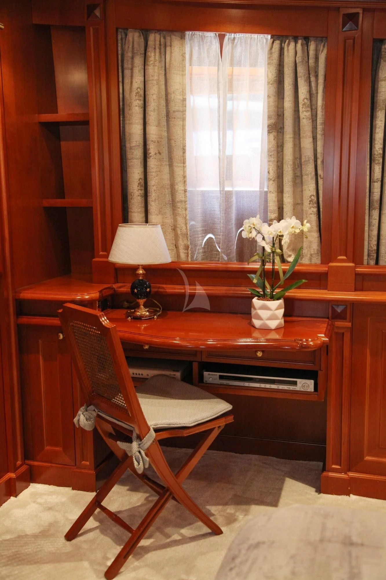 a chair in front of a window aboard AQUILA Yacht for Sale
