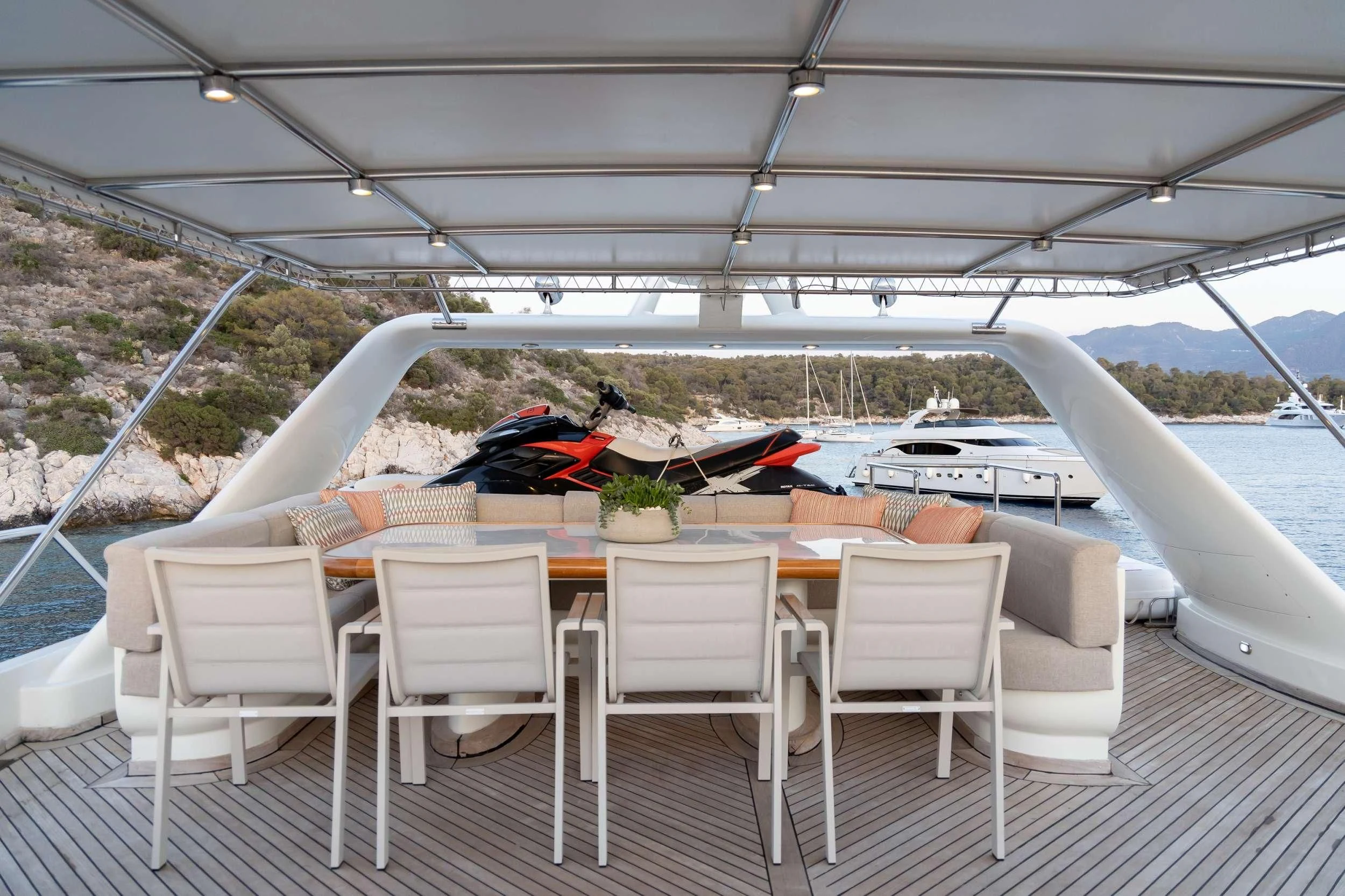 a table and chairs on a deck aboard AQUILA Yacht for Sale