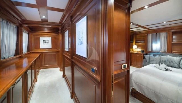 a room with a bed and a desk aboard AQUILA Yacht for Sale