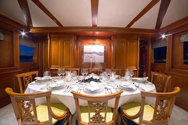 a dining room with a table set aboard AQUILA Yacht for Sale