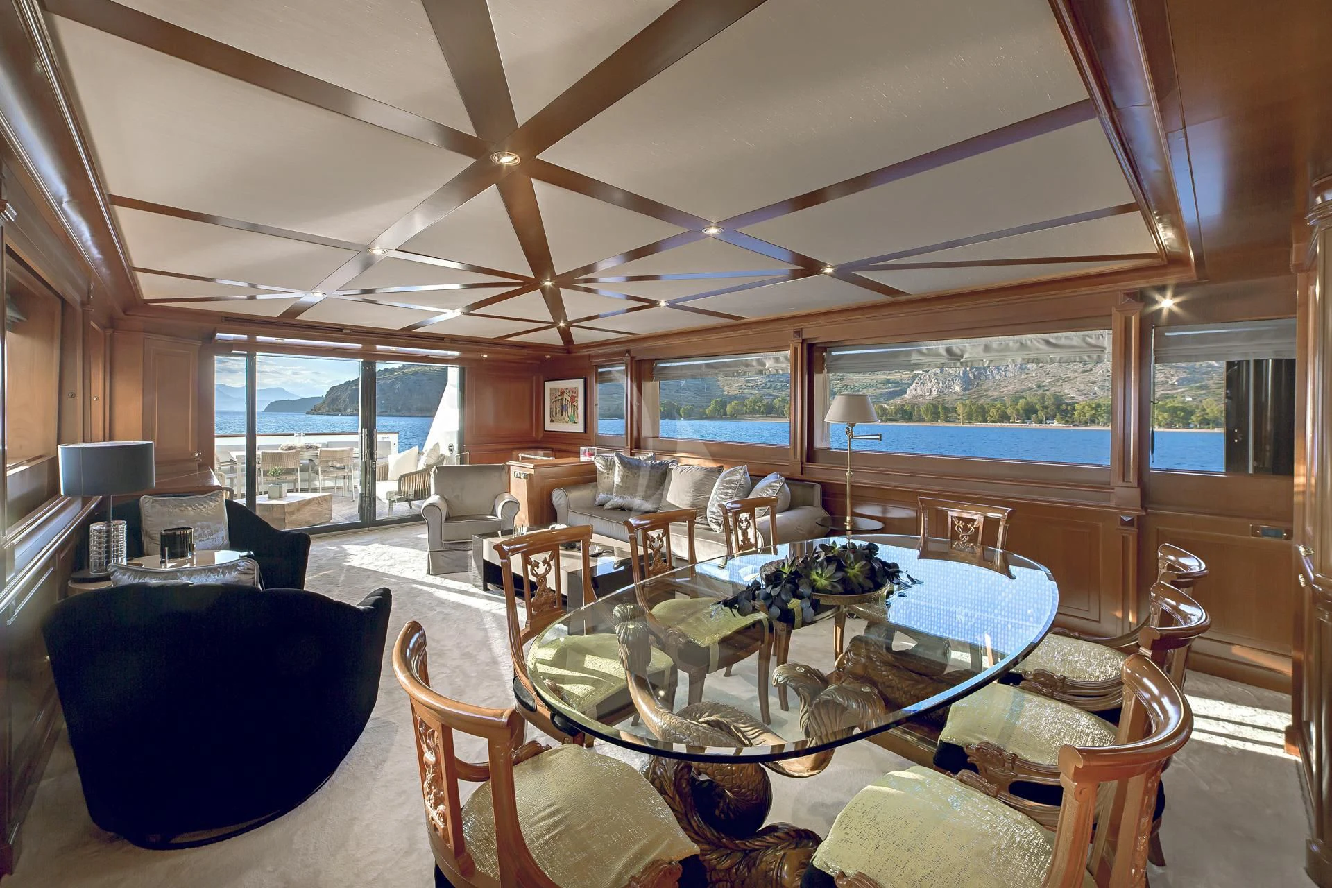 a large living room with a large table and chairs aboard AQUILA Yacht for Sale